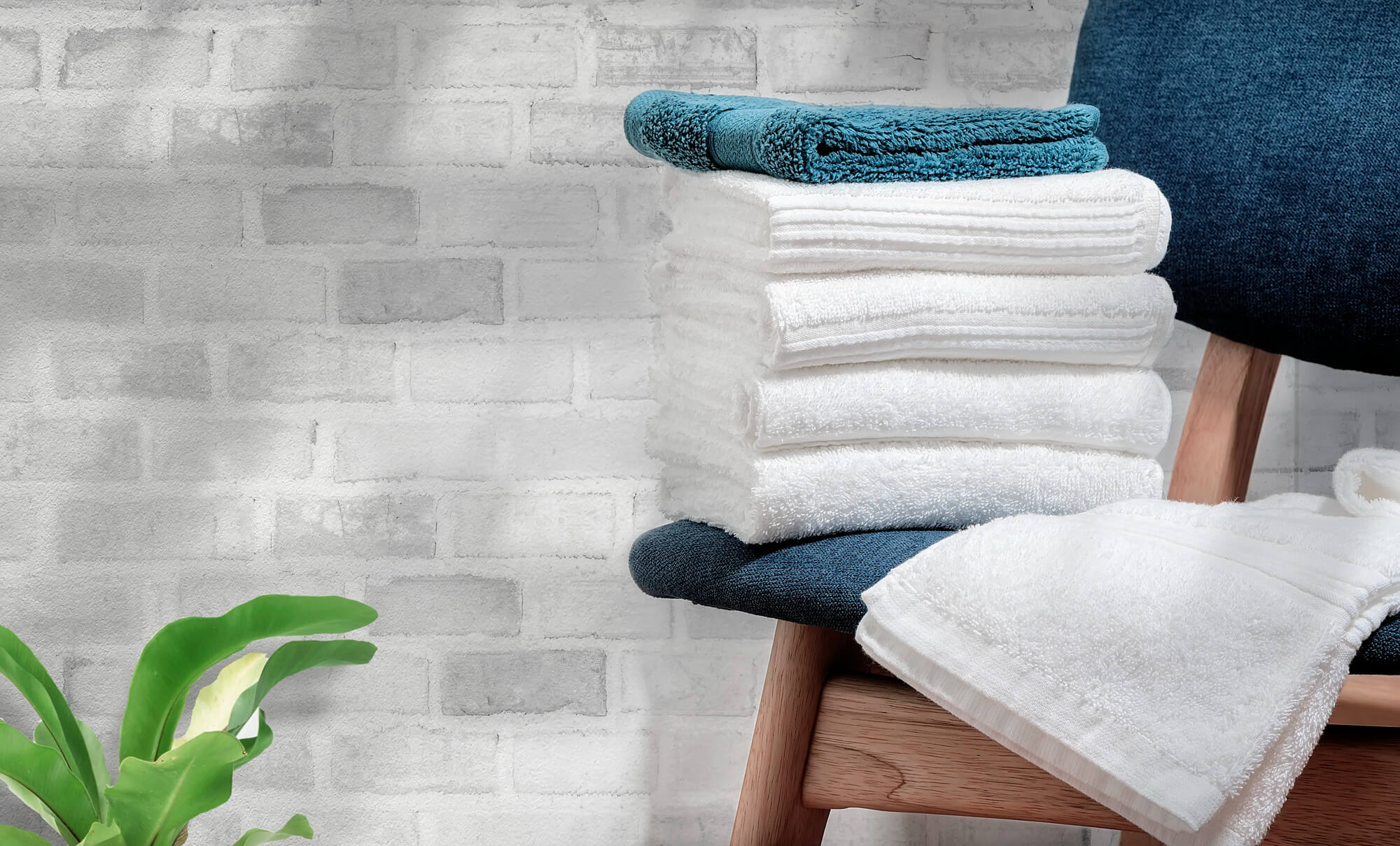 clean-terry-towels-wooden-chair-with-brick-wall-background-copy-space (1)